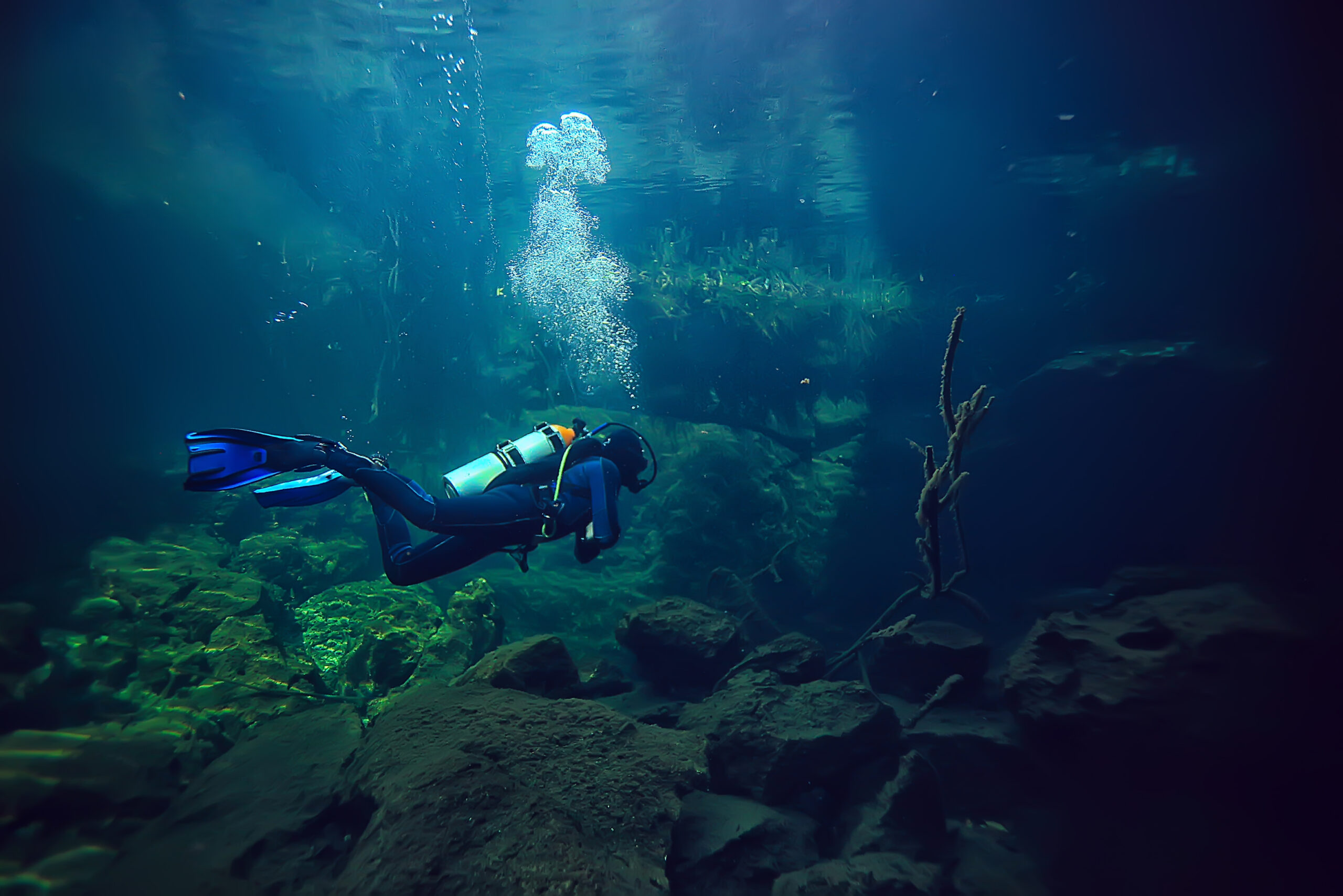 underwater world cave of yucatan cenote, dark landscape of stalactites underground, diver